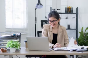 Nhân viên văn phòng soạn email chào hàng bằng tiếng Anh trên laptop